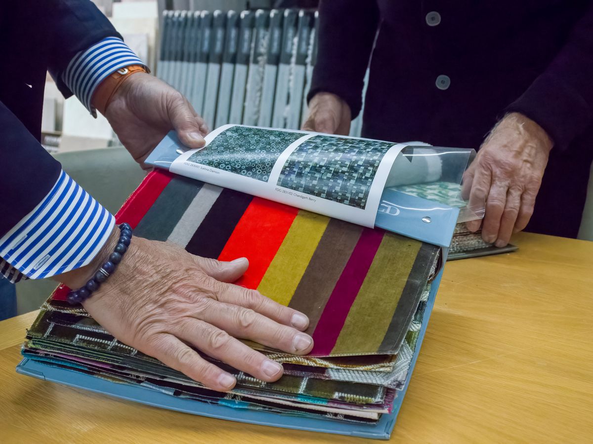 Flipping through fabric and wall covering sample books