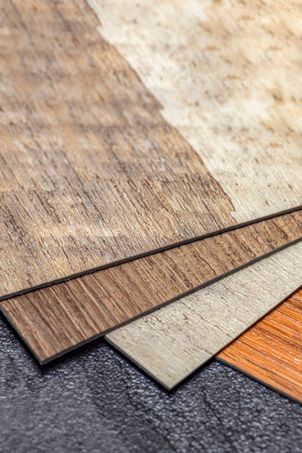 Stacked vinyl plank samples in wood and stone looks