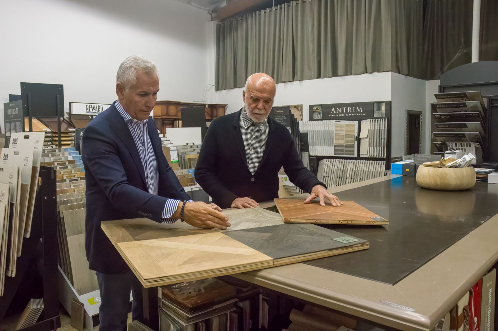 The founders of Interior Works reviewing parquet hardwood samples